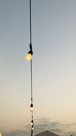 Lighting rod by sea against clear sky