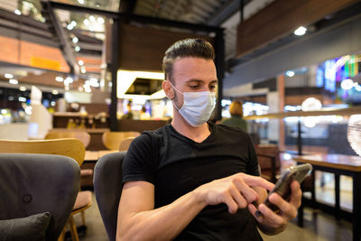 Man using mobile phone at cafe