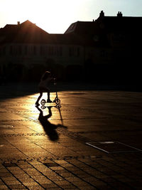 Boy on bicycle at sunset