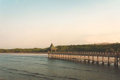 Scenic view of sea and building against clear sky