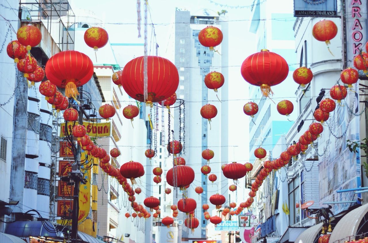 hanging, low angle view, decoration, red, in a row, lantern, variation, large group of objects, built structure, balloon, architecture, abundance, building exterior, lighting equipment, chinese lantern, multi colored, arrangement, celebration, side by side, flower