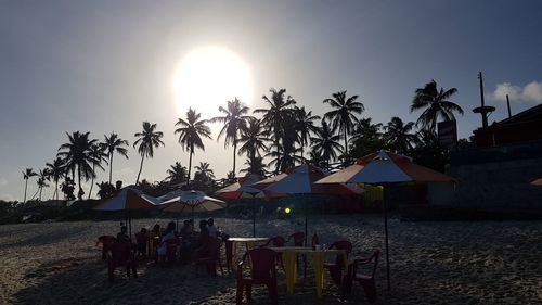 People at beach against sky