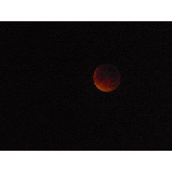 Close-up of red moon in the dark