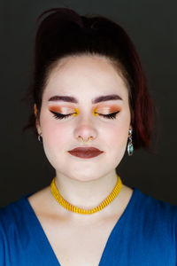 Portrait of young woman with eyes closed