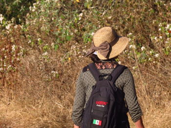 Rear view of man standing by hat