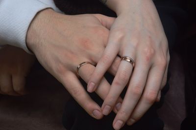 Cropped image of couple holding hands