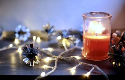 Close-up of illuminated tea light candles on table