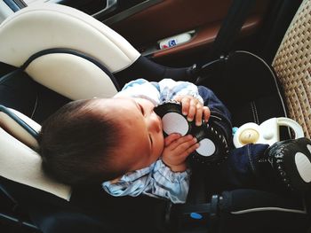 Rear view of boy sitting in car