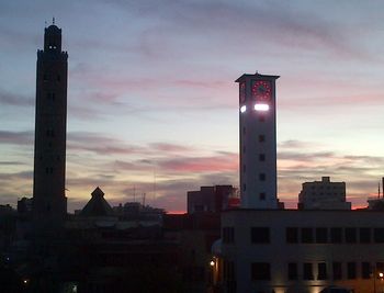 Low angle view of buildings against sky at sunset