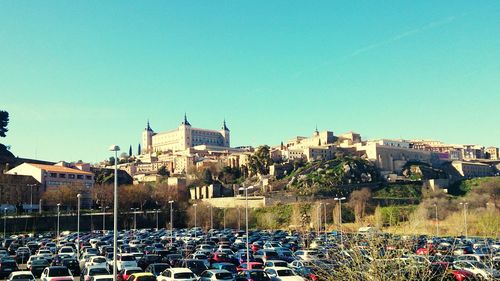 View of buildings in city against clear blue sky