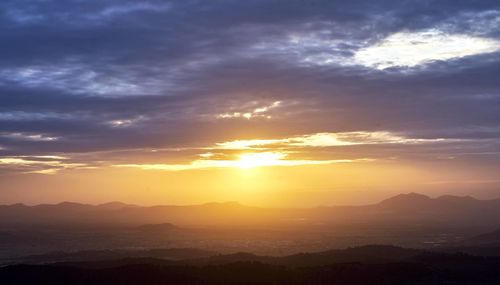 Scenic view of silhouette mountains against sky during sunset