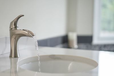 Close-up of faucet in bathroom at home