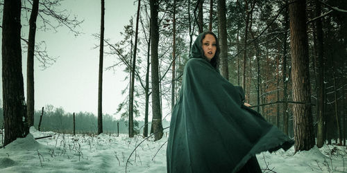 Woman standing on snow covered land
