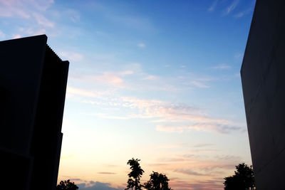 Low angle view of silhouette building against sky