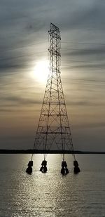 Silhouette ship on sea against sky during sunset