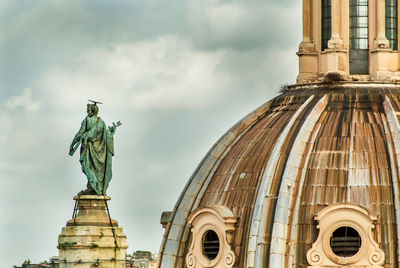 Low angle view of statue against cloudy sky