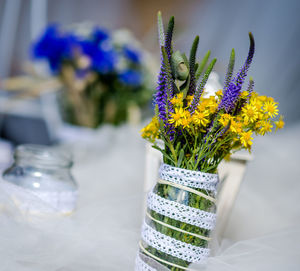 Close-up of flowers in mason jar on table