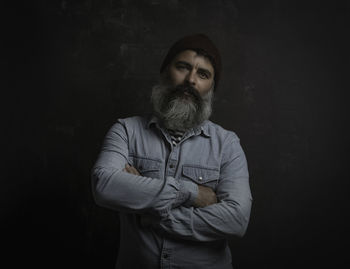 Portrait of handsome smiling man with beard and mustache. jeans shirt