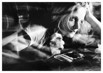 Thoughtful woman looking away by cocaine on coffee table