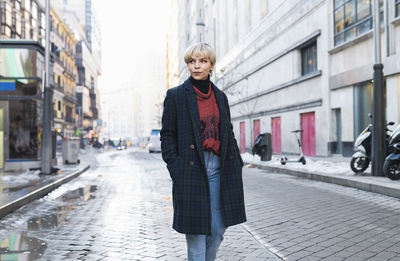 Full length of woman standing on street in city