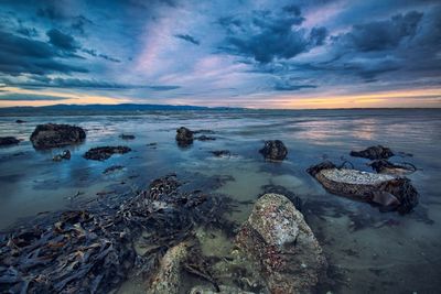 Scenic view of sea against cloudy sky
