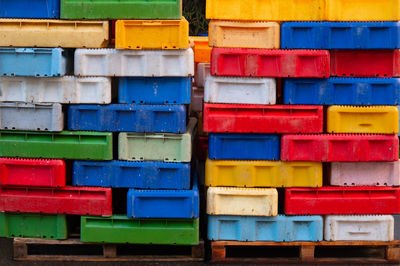 Colored fish boxes. stacked fishing containers.