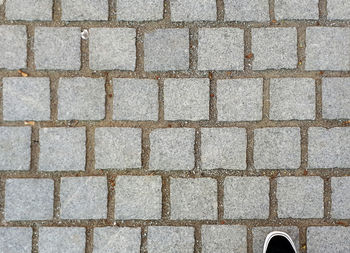 High angle view of tiled floor on footpath