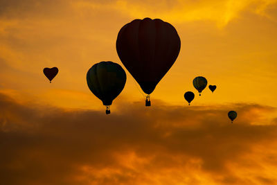 Low angle view of hot air balloons against sky during sunset