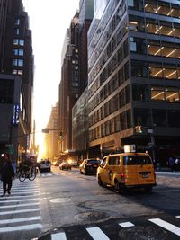 Cars on street amidst buildings in city