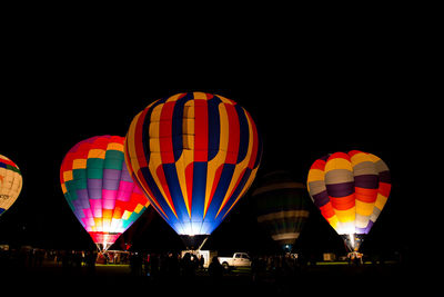 Multi colored hot air balloon against sky at night