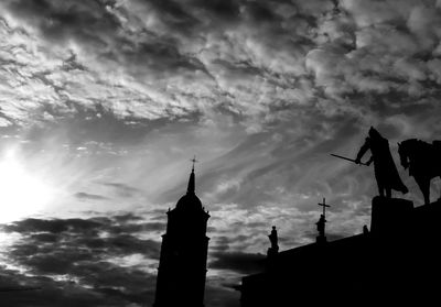 Low angle view of silhouette statue against sky during sunset