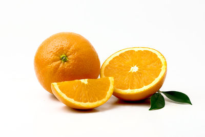 Close-up of orange fruit against white background