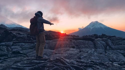 Full length of man standing on landscape during sunset