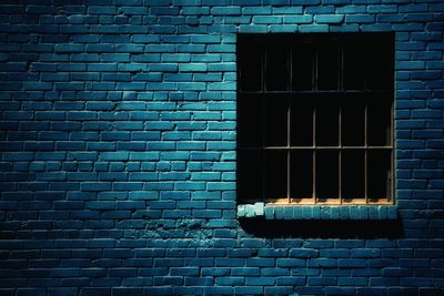 Close-up of window on brick wall