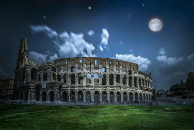 Castle against cloudy sky at night