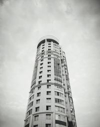 Low angle view of building against cloudy sky