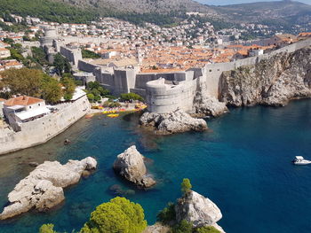 High angle view of sea against townscape