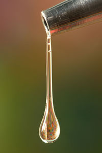 Close-up of water drop falling from pipe