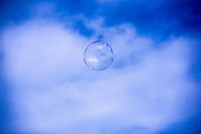 Low angle view of bubbles against sky