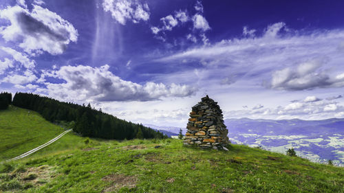 Panoramic view of cross on field against sky