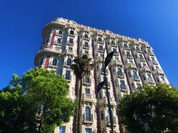 Low angle view of historical building against clear blue sky