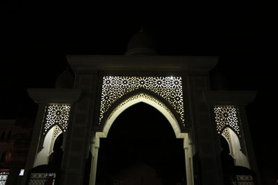 Low angle view of illuminated building at night