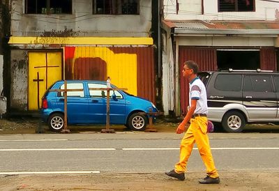 Side view of man standing on road