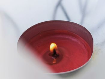 High angle view of lit tea light candle