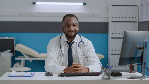 Portrait of female doctor working in office