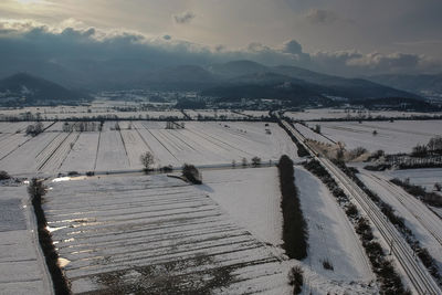 Scenic view of snow covered field against sky