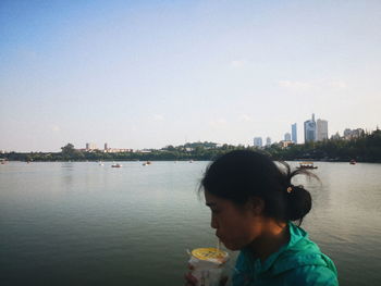 Portrait of boy in river against sky