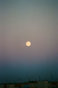 Low angle view of moon against clear sky at dusk