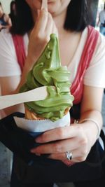 Midsection of woman holding ice cream