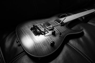 High angle view of guitar on sofa